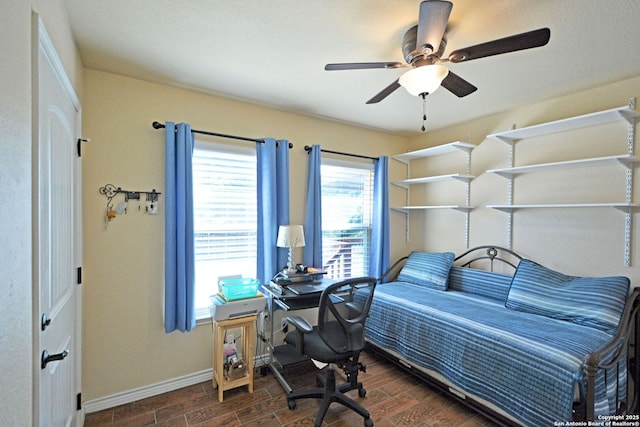 bedroom with baseboards, ceiling fan, and wood tiled floor