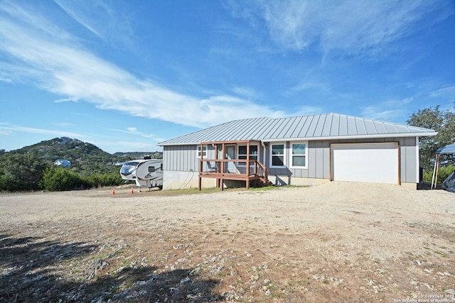 view of front of property with a standing seam roof, metal roof, board and batten siding, and a garage