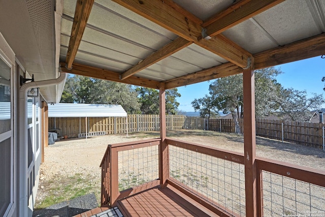 wooden terrace featuring a fenced backyard