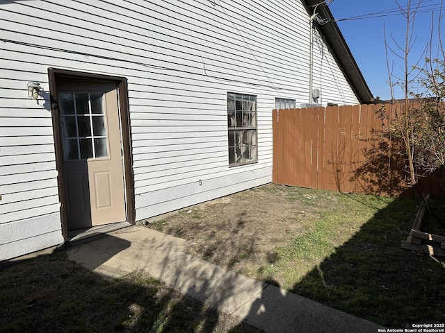 view of home's exterior featuring a yard and fence