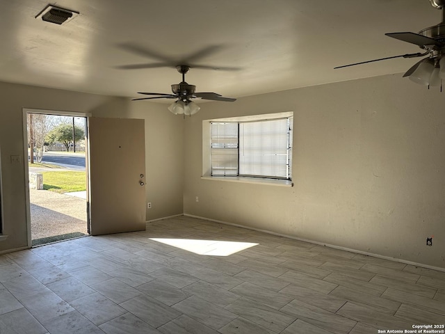 unfurnished room with ceiling fan and visible vents