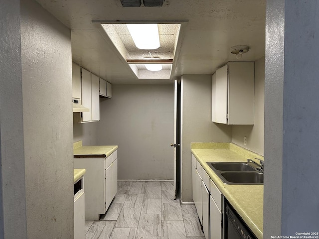 kitchen featuring black dishwasher, light countertops, a sink, and under cabinet range hood