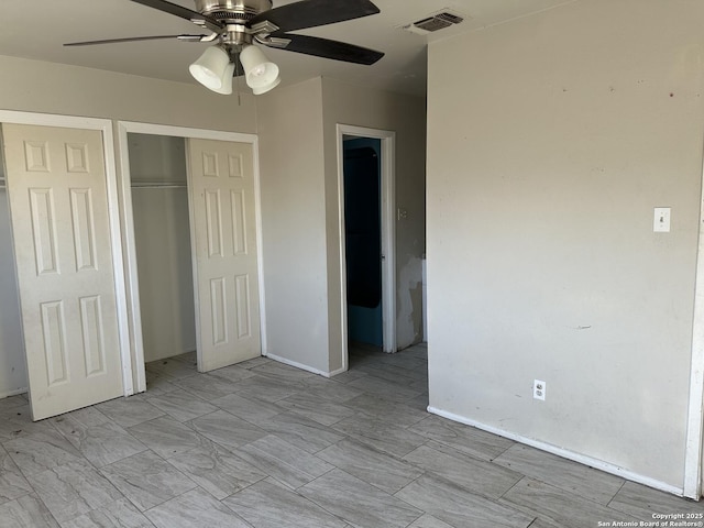 unfurnished bedroom featuring a closet, visible vents, and a ceiling fan