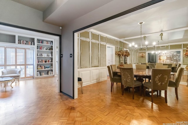 dining space with an inviting chandelier and built in shelves