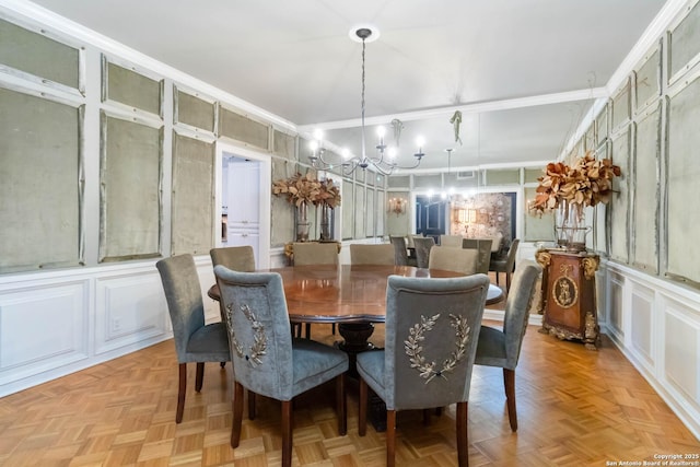 dining space with an inviting chandelier and a decorative wall