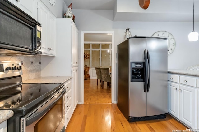 kitchen featuring stainless steel appliances, light countertops, backsplash, and white cabinetry