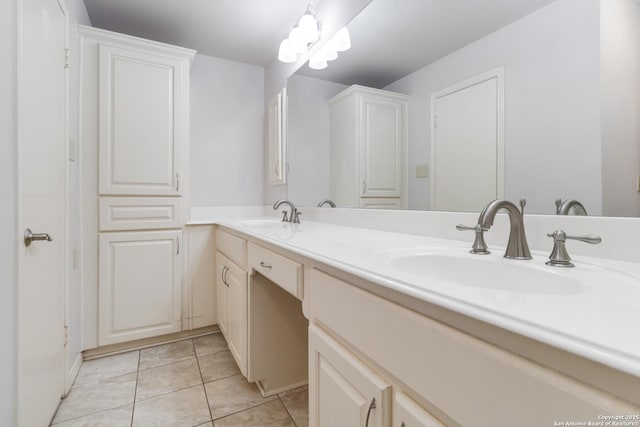 bathroom featuring double vanity, a sink, and tile patterned floors