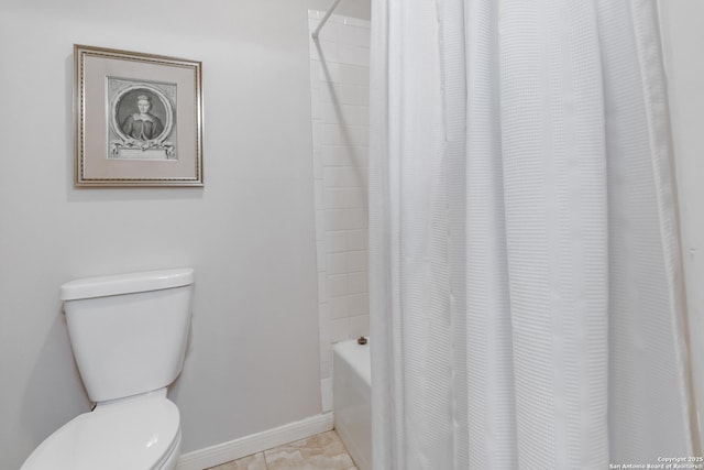 bathroom featuring shower / tub combo, tile patterned floors, toilet, and baseboards