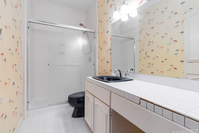 bathroom with toilet, a stall shower, vanity, tile patterned flooring, and wallpapered walls