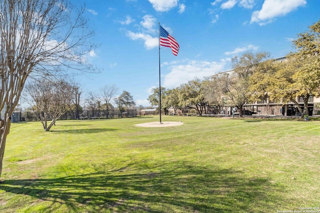 view of home's community with a yard