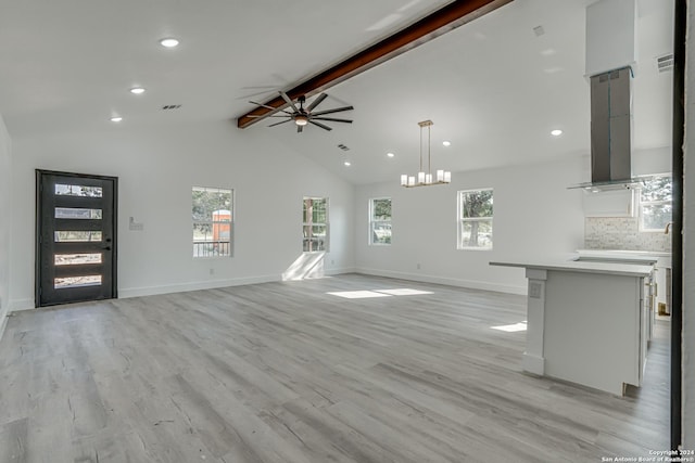 unfurnished living room featuring light wood finished floors, a ceiling fan, baseboards, and beamed ceiling