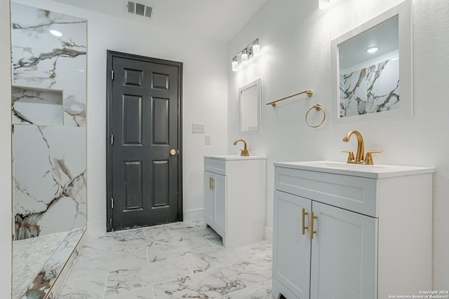 bathroom with a marble finish shower, visible vents, a sink, marble finish floor, and two vanities