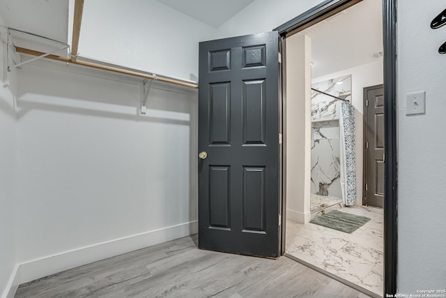 spacious closet featuring wood finished floors