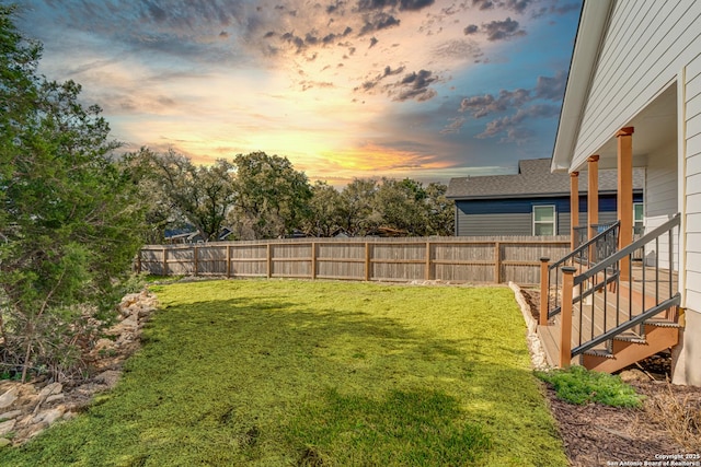 yard at dusk featuring fence