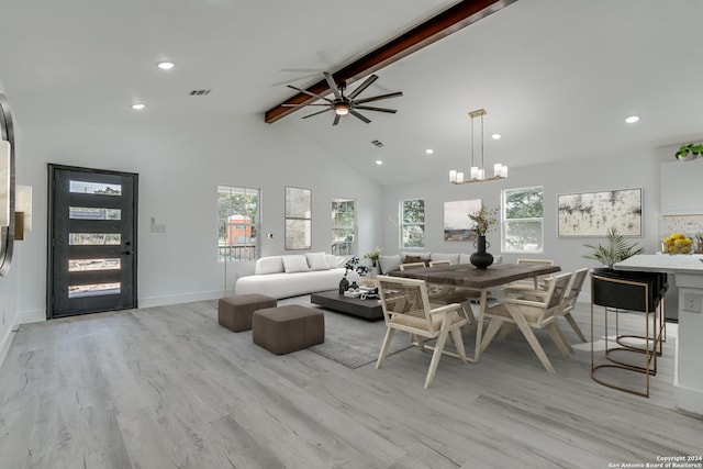 living room with a wealth of natural light, visible vents, beamed ceiling, and wood finished floors