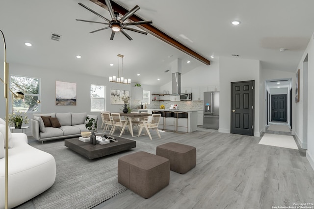 living room with light wood-style floors, beam ceiling, visible vents, and plenty of natural light