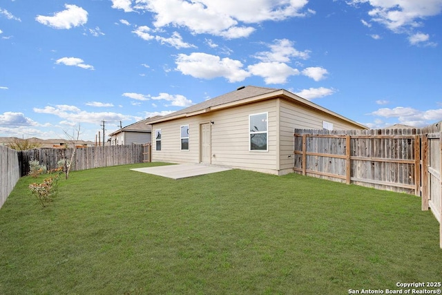 back of property featuring a patio area, a fenced backyard, and a yard