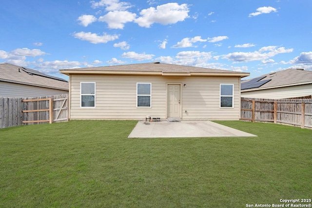 back of house featuring a fenced backyard, a lawn, and a patio