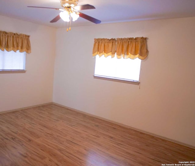 spare room featuring a ceiling fan and wood finished floors