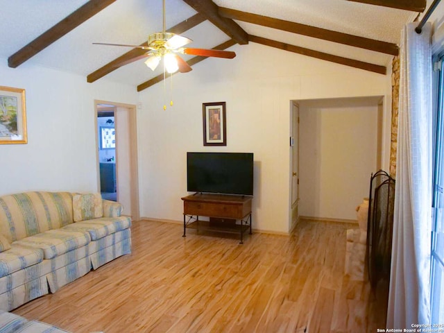 living room with light wood-type flooring, ceiling fan, lofted ceiling with beams, and baseboards