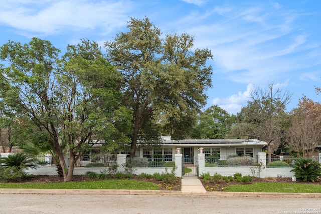 single story home with a fenced front yard