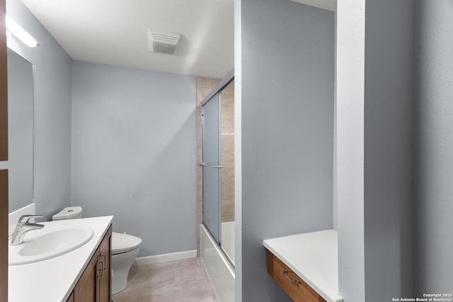 bathroom featuring visible vents, shower / bath combination with glass door, vanity, and toilet