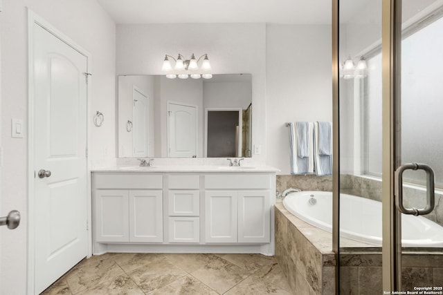 bathroom featuring double vanity, a sink, and a bath