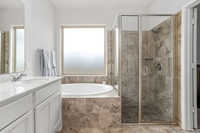 bathroom featuring a bath, a shower stall, and vanity