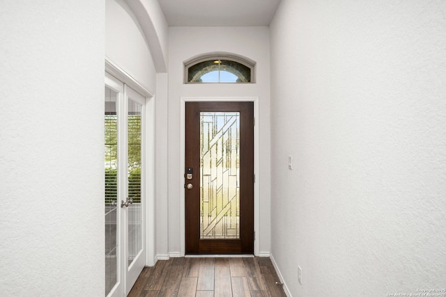 foyer entrance with baseboards and wood finished floors