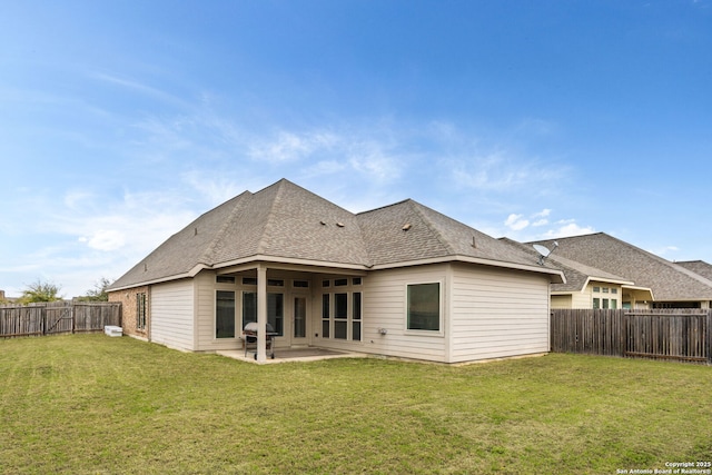 back of house featuring a fenced backyard, a lawn, and a patio