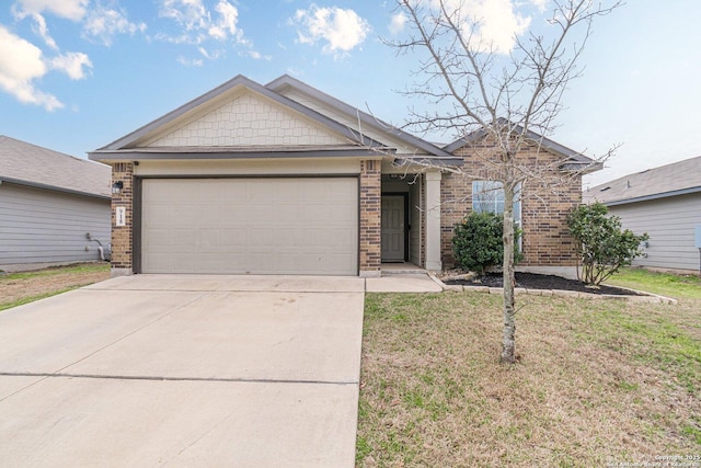 view of front of home featuring a front lawn, concrete driveway, brick siding, and an attached garage