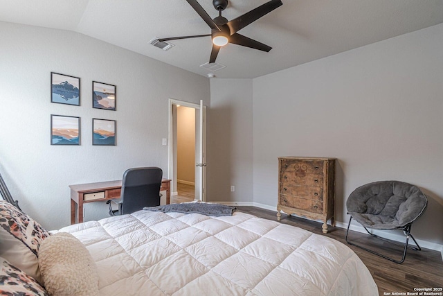 bedroom with vaulted ceiling, wood finished floors, visible vents, and baseboards