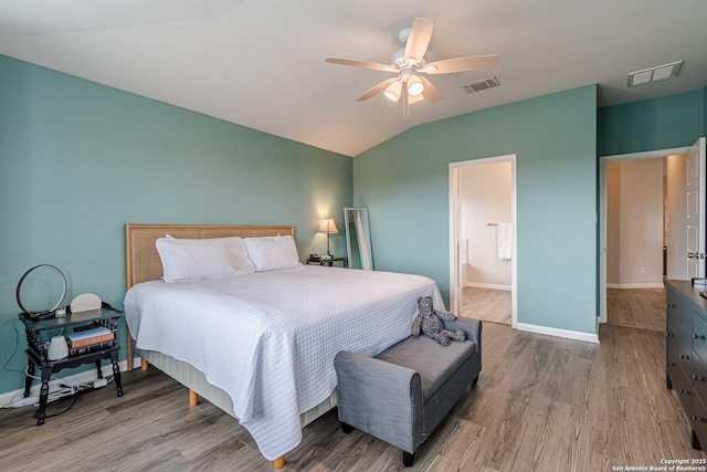 bedroom featuring lofted ceiling, visible vents, and wood finished floors