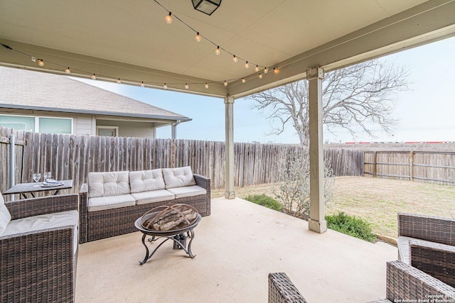 view of patio / terrace featuring an outdoor living space with a fire pit and a fenced backyard