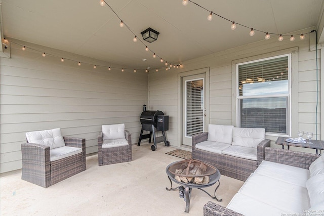 view of patio with a grill and an outdoor living space with a fire pit