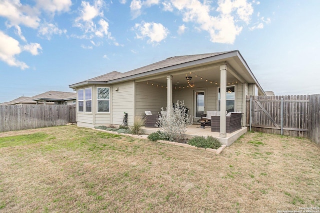 rear view of house featuring a patio, a lawn, a fenced backyard, and an outdoor living space