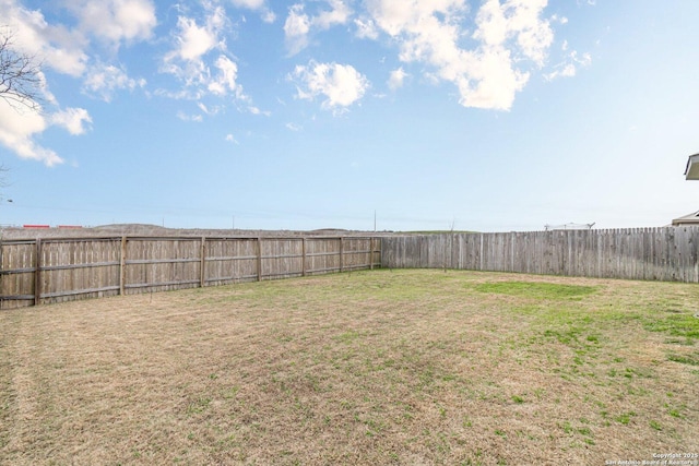 view of yard with a fenced backyard