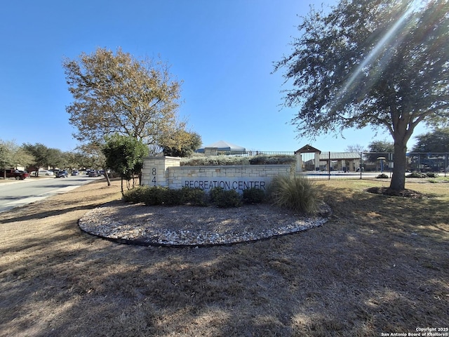 community sign featuring fence