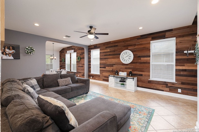 living area featuring wooden walls, visible vents, ceiling fan with notable chandelier, light tile patterned flooring, and recessed lighting