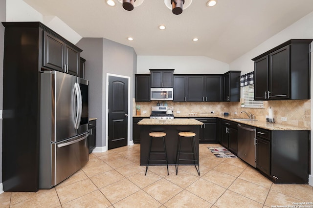 276 Cita Roost, San Antonio, TX 78253 - kitchen featuring light tile patterned floors, vaulted ceiling, stainless steel appliances, and a center island