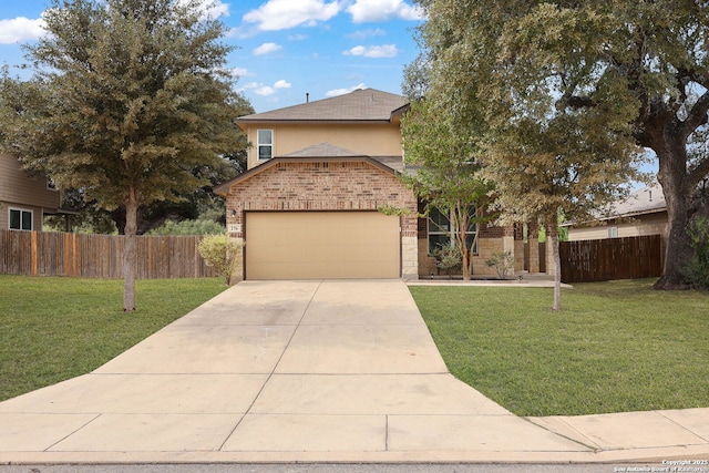 traditional home featuring brick siding, an attached garage, fence, driveway, and a front lawn