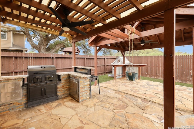 276 Cita Roost, San Antonio, TX 78253 - view of patio / terrace with a fenced backyard, a grill, a ceiling fan, and exterior kitchen