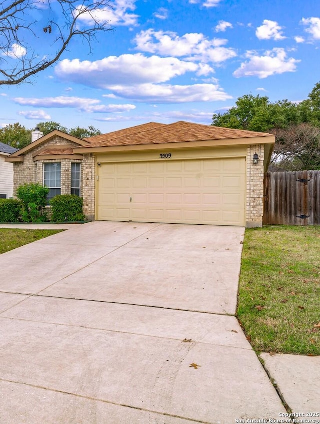 single story home with concrete driveway, brick siding, an attached garage, and fence