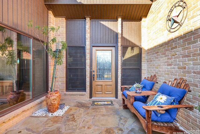 view of exterior entry with brick siding