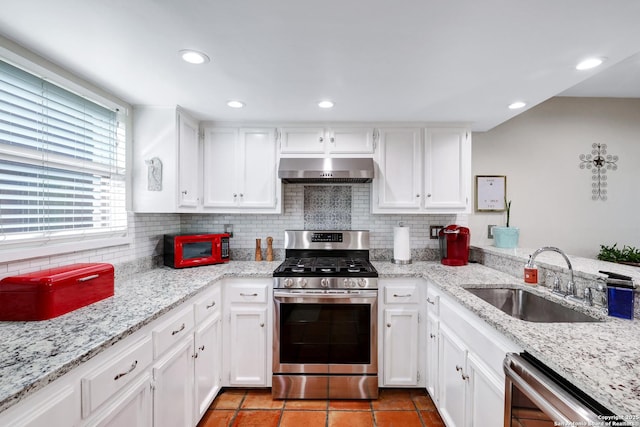 kitchen with dishwashing machine, a sink, white cabinets, ventilation hood, and gas range