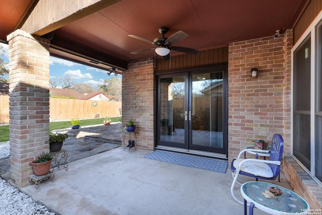 view of patio with fence, a ceiling fan, and french doors