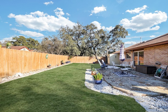 view of yard with a fenced backyard and a patio