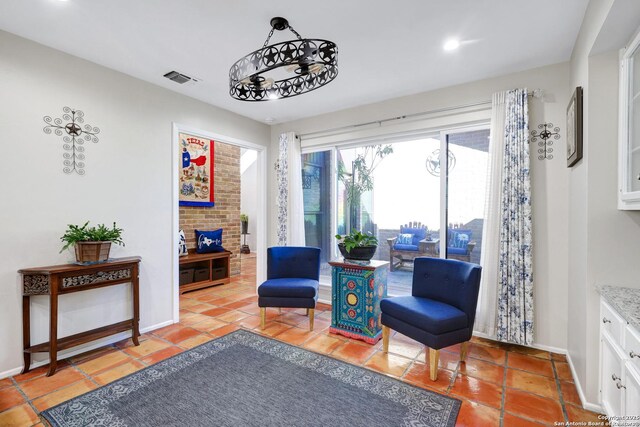 living area with visible vents and baseboards