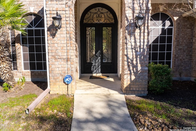 doorway to property featuring brick siding