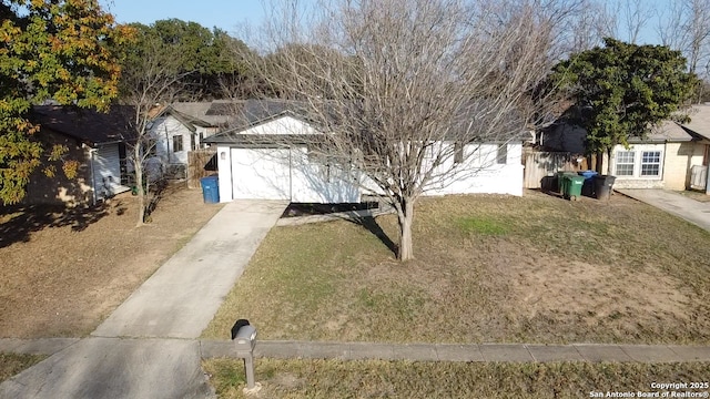 view of front of home with a front lawn and concrete driveway